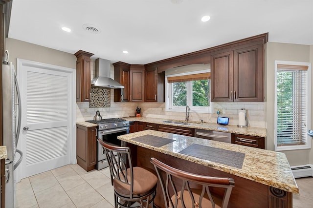 70 Walter Dr, Stony Point, NY 10980 - kitchen featuring wall chimney exhaust hood, appliances with stainless steel finishes, tasteful backsplash, baseboard heating, and light tile patterned flooring