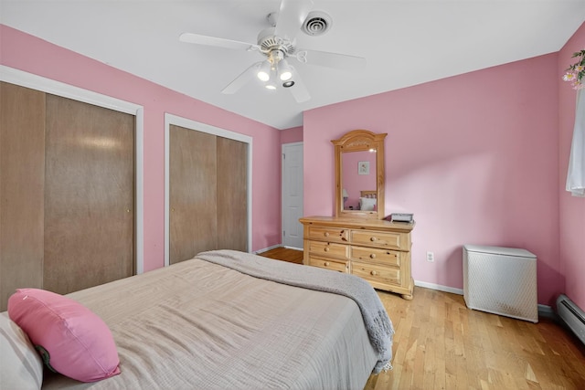 70 Walter Dr, Stony Point, NY 10980 - bedroom featuring multiple closets, light wood-type flooring, a baseboard radiator, and a ceiling fan