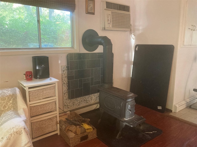 46 Violet Rd, Rocky Point, NY 11778 - bathroom featuring a wood stove, an AC wall unit, and wood finished floors