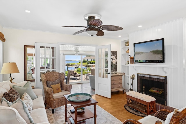 315 Old Salt Rd, Mattituck, NY 11952 - living room with ceiling fan, french doors, wood finished floors, built in features, and a fireplace