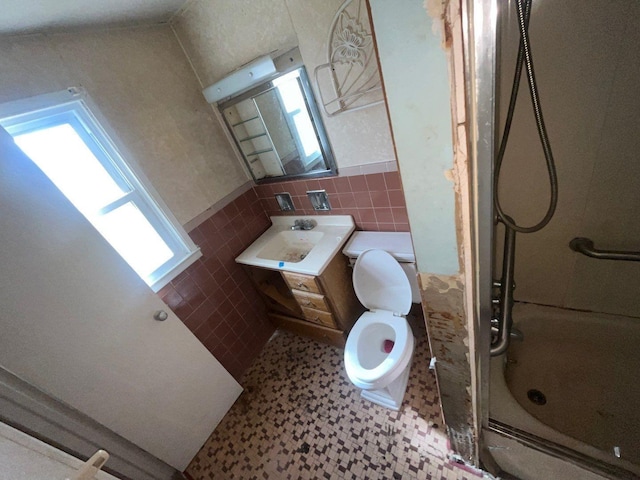 625 Edwards St Unit A, Westhampton Beach, NY 11978 - full bath featuring tile walls, a shower, vanity, and wainscoting