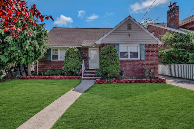 502 S 11th St, New Hyde Park, NY 11040 - view of front of home with brick siding and roof with shingles