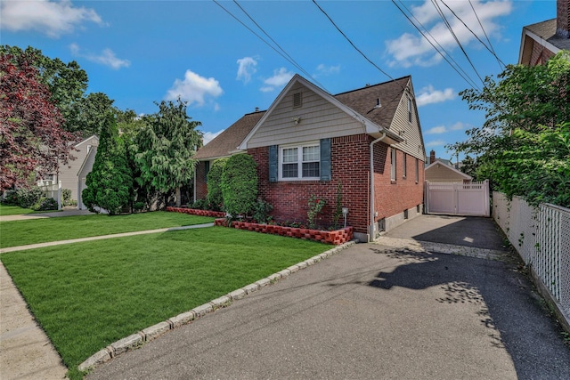 502 S 11th St, New Hyde Park, NY 11040 - view of front of home with brick siding and a detached garage