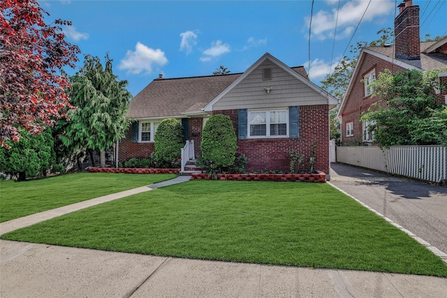 502 S 11th St, New Hyde Park, NY 11040 - view of front of property featuring brick siding and asphalt driveway