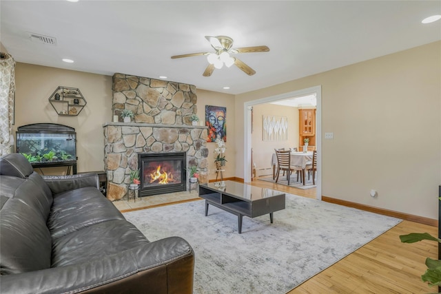 502 S 11th St, New Hyde Park, NY 11040 - living area with ceiling fan, wood finished floors, a stone fireplace, and recessed lighting