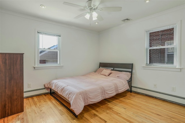 502 S 11th St, New Hyde Park, NY 11040 - bedroom featuring a baseboard heating unit, crown molding, light wood-type flooring, and ceiling fan
