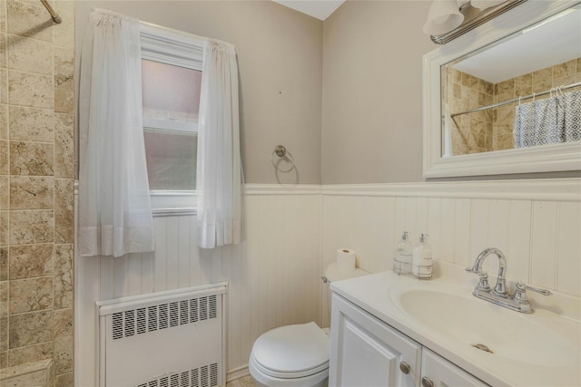 502 S 11th St, New Hyde Park, NY 11040 - bathroom featuring radiator, a tile shower, vanity, and wainscoting