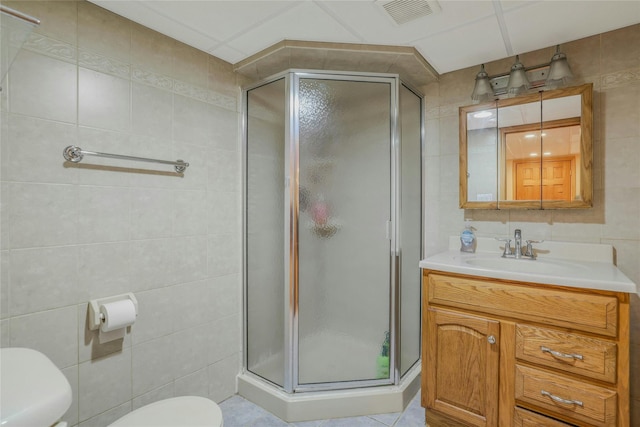 502 S 11th St, New Hyde Park, NY 11040 - bathroom featuring tile walls, vanity, a stall shower, and tile patterned floors