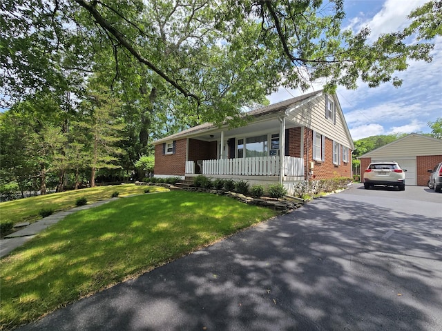 3 Birch St, Airmont, NY 10952 - view of front of house featuring a porch, brick siding, a front lawn, and a garage