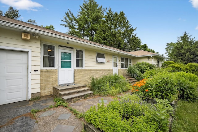 7641 N Broadway, Red Hook, NY 12571 - view of front of property featuring brick siding, a garage, and entry steps