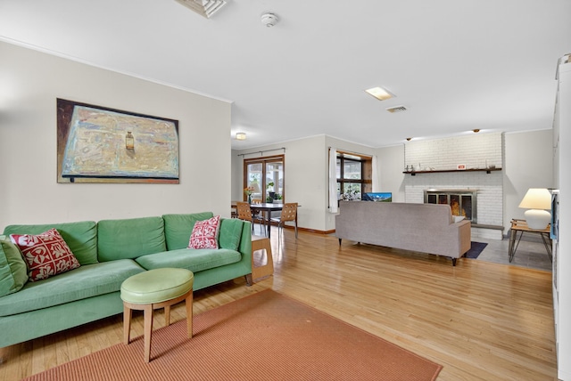 7641 N Broadway, Red Hook, NY 12571 - living area featuring light wood-style floors, crown molding, and a fireplace
