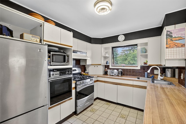 7641 N Broadway, Red Hook, NY 12571 - kitchen with stainless steel appliances, open shelves, under cabinet range hood, and white cabinetry