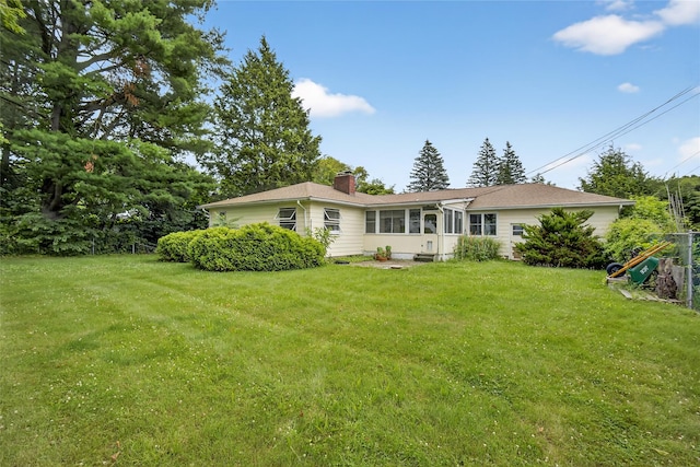 7641 N Broadway, Red Hook, NY 12571 - rear view of property featuring a chimney and a lawn