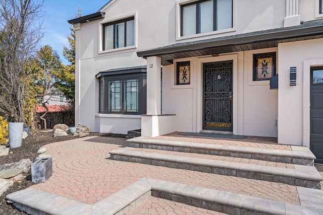12 Foxhurst Ct, Manhasset Hills, NY 11040 - entrance to property with stucco siding and a porch