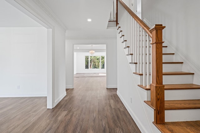 12 Foxhurst Ct, Manhasset Hills, NY 11040 - stairs with wood finished floors, a chandelier, crown molding, and recessed lighting