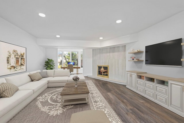 12 Foxhurst Ct, Manhasset Hills, NY 11040 - living area featuring dark wood-style floors, recessed lighting, and a warm lit fireplace