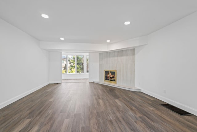 12 Foxhurst Ct, Manhasset Hills, NY 11040 - unfurnished living room with recessed lighting, dark wood finished floors, and a high end fireplace