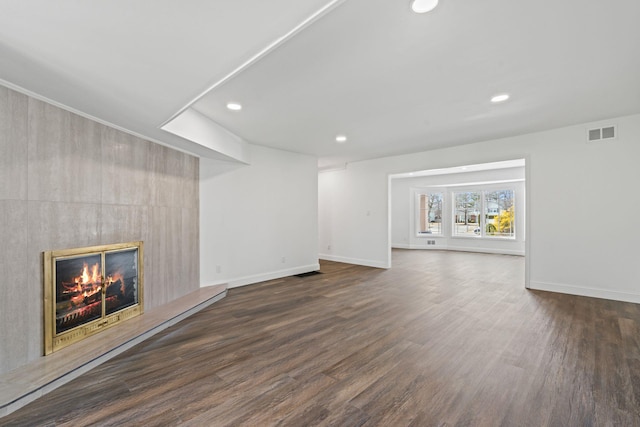 12 Foxhurst Ct, Manhasset Hills, NY 11040 - unfurnished living room featuring recessed lighting, a large fireplace, and dark wood finished floors