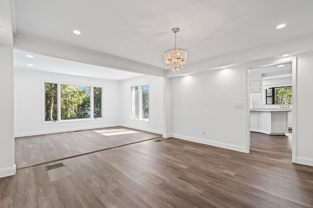 12 Foxhurst Ct, Manhasset Hills, NY 11040 - unfurnished room with a chandelier, dark wood-type flooring, recessed lighting, and crown molding