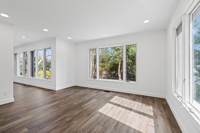 12 Foxhurst Ct, Manhasset Hills, NY 11040 - spare room featuring healthy amount of natural light, dark wood-type flooring, ornamental molding, and recessed lighting