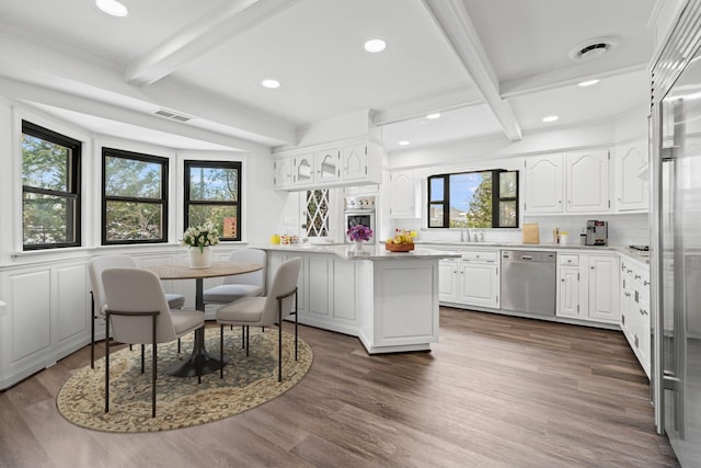 12 Foxhurst Ct, Manhasset Hills, NY 11040 - kitchen featuring appliances with stainless steel finishes, beam ceiling, healthy amount of natural light, light countertops, and decorative backsplash