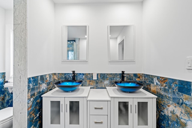 12 Foxhurst Ct, Manhasset Hills, NY 11040 - full bath featuring tile walls, double vanity, and a wainscoted wall