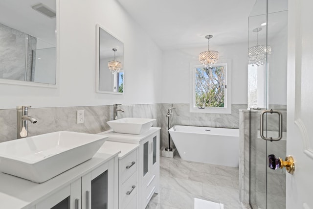 12 Foxhurst Ct, Manhasset Hills, NY 11040 - full bath with tile walls, a chandelier, a stall shower, double vanity, and marble finish floors