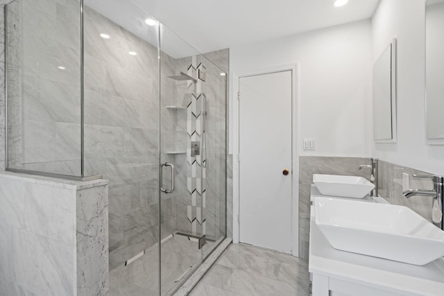 12 Foxhurst Ct, Manhasset Hills, NY 11040 - bathroom with a shower stall, double vanity, tile walls, marble finish floors, and recessed lighting