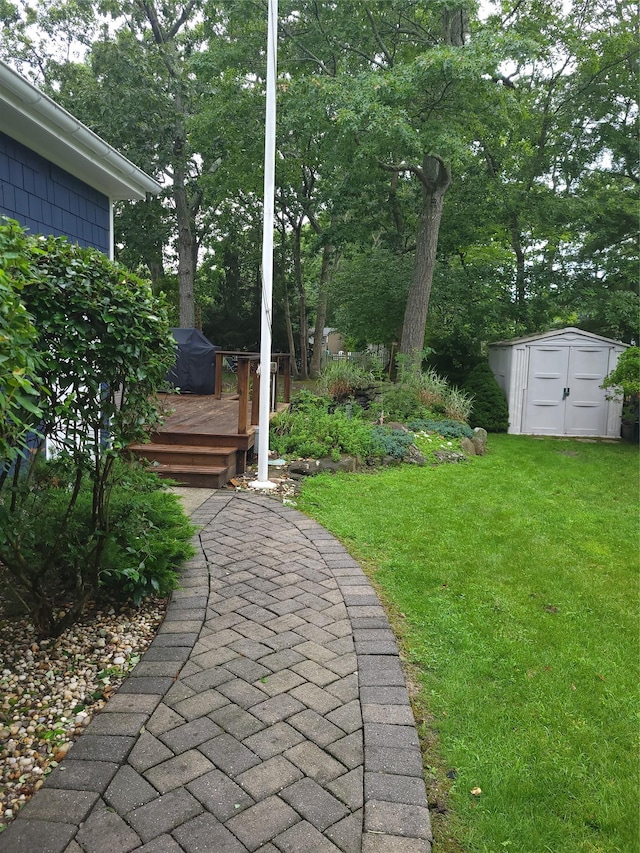 67 Wakeman Rd, Hampton Bays, NY 11946 - view of green lawn with a shed, a wooden deck, and view of wooded area