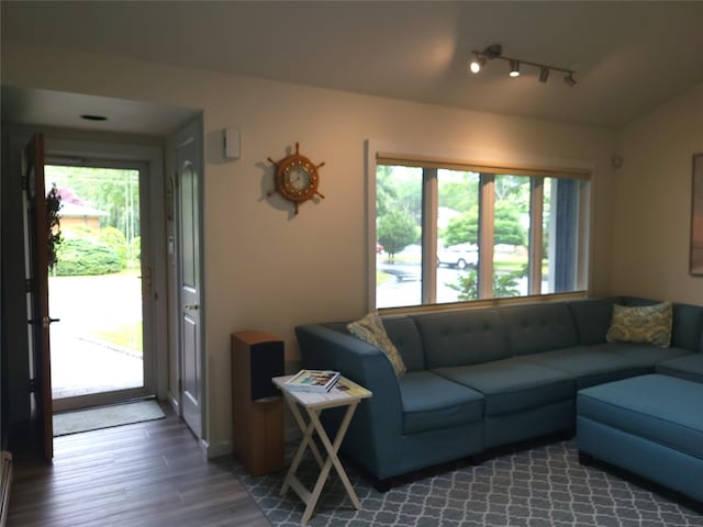 67 Wakeman Rd, Hampton Bays, NY 11946 - living area with wood finished floors, track lighting, and vaulted ceiling