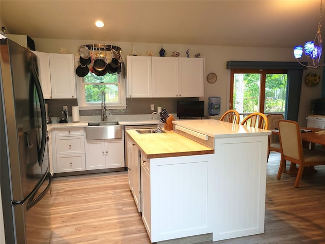 67 Wakeman Rd, Hampton Bays, NY 11946 - kitchen with freestanding refrigerator, wooden counters, healthy amount of natural light, light wood-type flooring, and recessed lighting