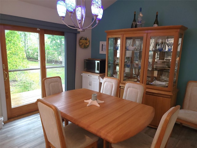 67 Wakeman Rd, Hampton Bays, NY 11946 - dining space with a chandelier, light wood finished floors, and lofted ceiling