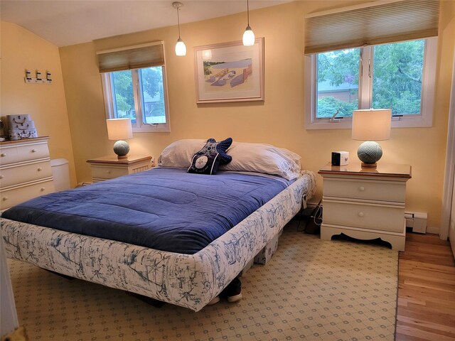 67 Wakeman Rd, Hampton Bays, NY 11946 - bedroom with baseboard heating and wood finished floors