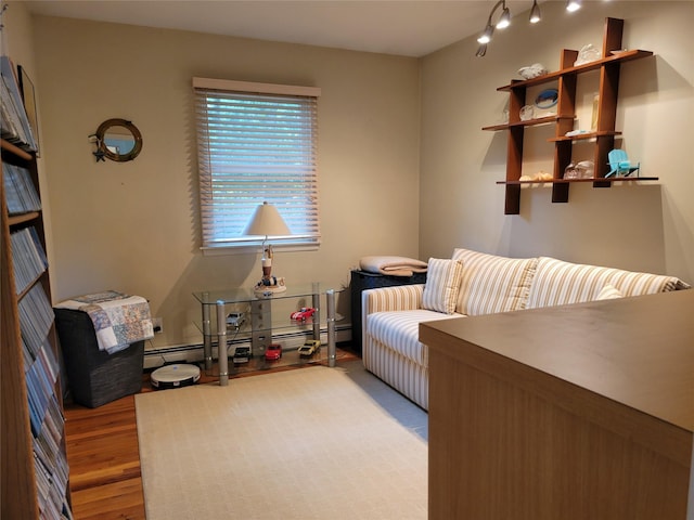 67 Wakeman Rd, Hampton Bays, NY 11946 - bedroom with wood finished floors and a baseboard radiator