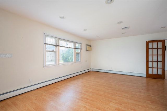 21 Silver St, West Babylon, NY 11704 - empty room featuring wood finished floors, a baseboard radiator, a wall mounted air conditioner, and recessed lighting