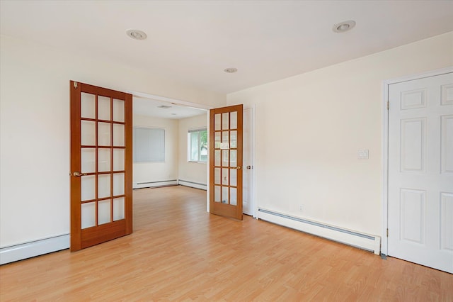21 Silver St, West Babylon, NY 11704 - spare room with a baseboard radiator, wood finished floors, and french doors