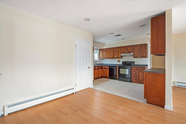 21 Silver St, West Babylon, NY 11704 - kitchen with black appliances, baseboard heating, dark countertops, under cabinet range hood, and brown cabinets