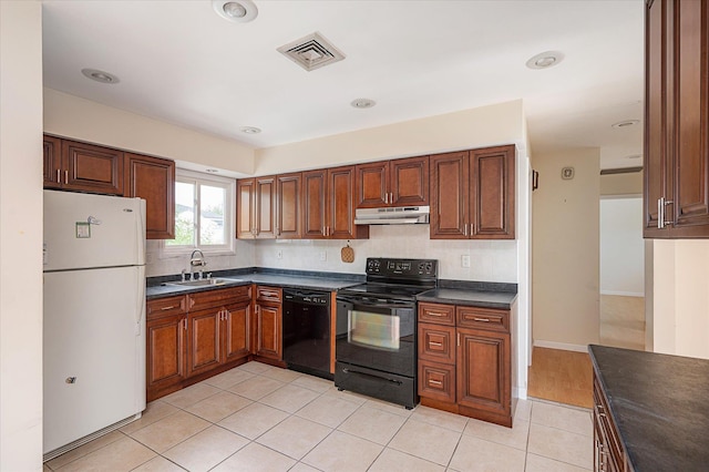 21 Silver St, West Babylon, NY 11704 - kitchen with black appliances, dark countertops, under cabinet range hood, decorative backsplash, and light tile patterned flooring