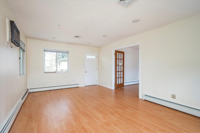 21 Silver St, West Babylon, NY 11704 - unfurnished room with a baseboard heating unit and light wood-style floors