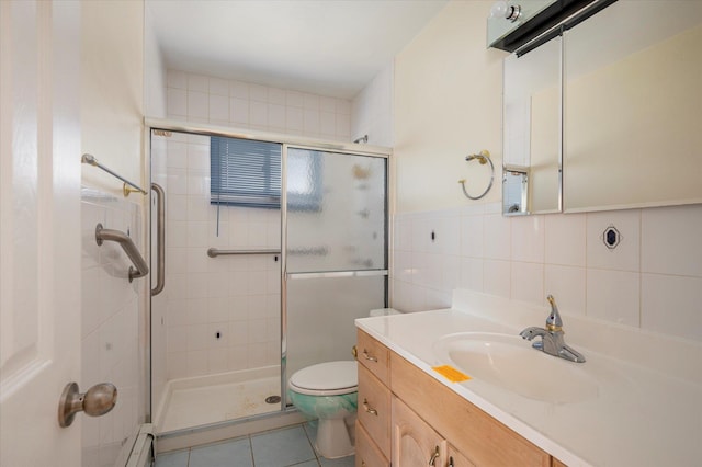 21 Silver St, West Babylon, NY 11704 - full bath with a shower stall, vanity, tile patterned flooring, a baseboard heating unit, and tile walls