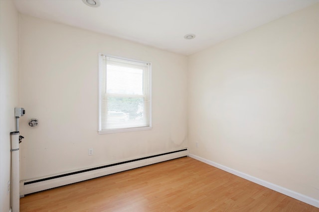 21 Silver St, West Babylon, NY 11704 - spare room with a baseboard heating unit and wood finished floors
