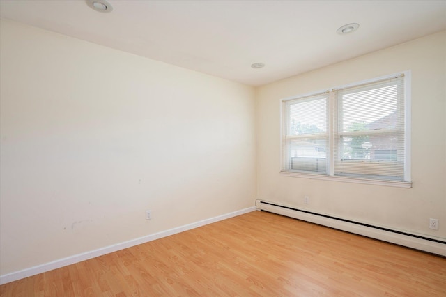 21 Silver St, West Babylon, NY 11704 - spare room with baseboard heating and light wood finished floors