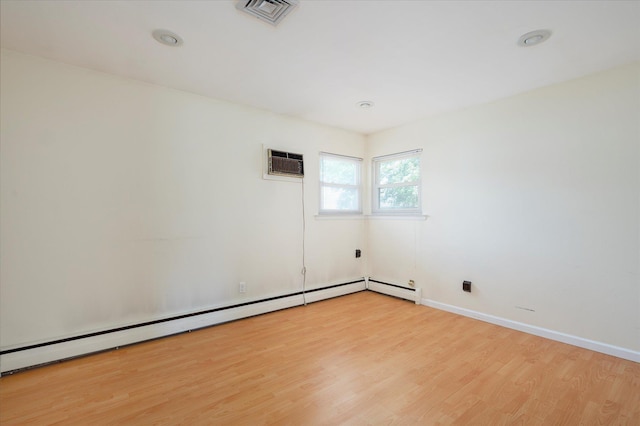 21 Silver St, West Babylon, NY 11704 - empty room with light wood-type flooring, a wall mounted air conditioner, baseboard heating, and recessed lighting