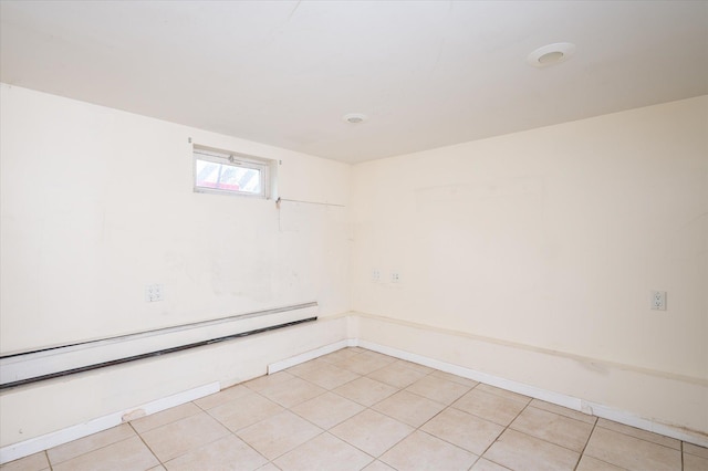21 Silver St, West Babylon, NY 11704 - empty room with a baseboard heating unit and light tile patterned floors