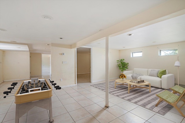 21 Silver St, West Babylon, NY 11704 - living room featuring light tile patterned floors and baseboards