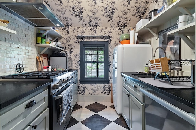 259 Westchester Ave, Pound Ridge, NY 10576 - kitchen featuring gas range, wallpapered walls, wall chimney range hood, open shelves, and freestanding refrigerator
