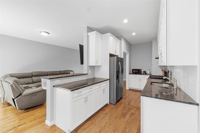 28 Pinto Rd W, Middletown, NY 10941 - kitchen with stainless steel refrigerator with ice dispenser, white cabinetry, dark stone countertops, light wood-style floors, and recessed lighting