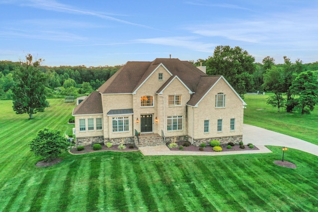 28 Viola Ct, Wappingers Falls, NY 12590 - traditional-style house featuring a front yard, stone siding, and roof with shingles
