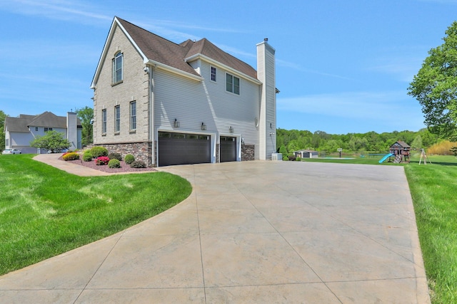 28 Viola Ct, Wappingers Falls, NY 12590 - view of side of home with an attached garage, concrete driveway, a lawn, a chimney, and stone siding