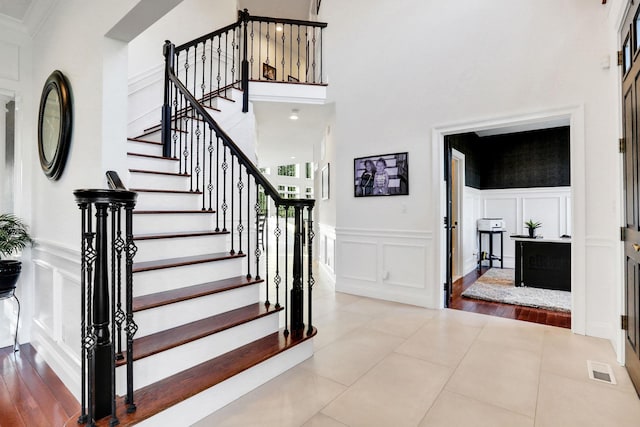 28 Viola Ct, Wappingers Falls, NY 12590 - stairway with a decorative wall, wainscoting, and a high ceiling